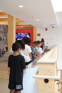 Students exploring an exhibit near the Crispus Attucks York Community Oral History display