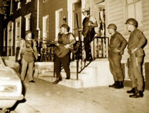 Police in riot gear outside a row home in York during searches in July 1969